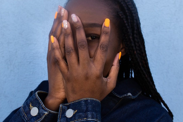 The African American covered her face with her hand, portrait