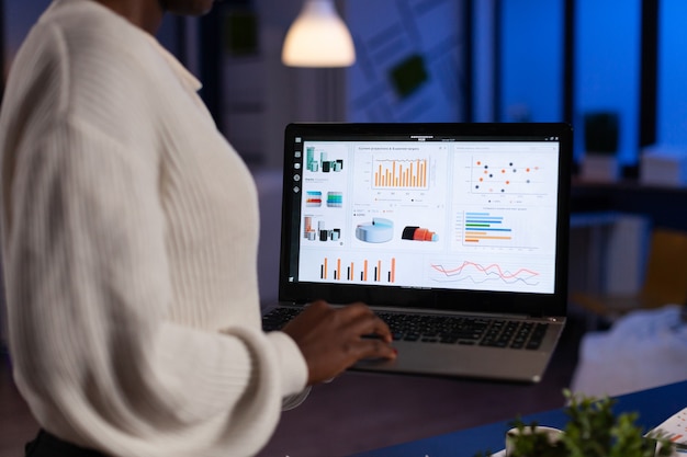 Photo african american entrepreneur woman analyzing financial graphs