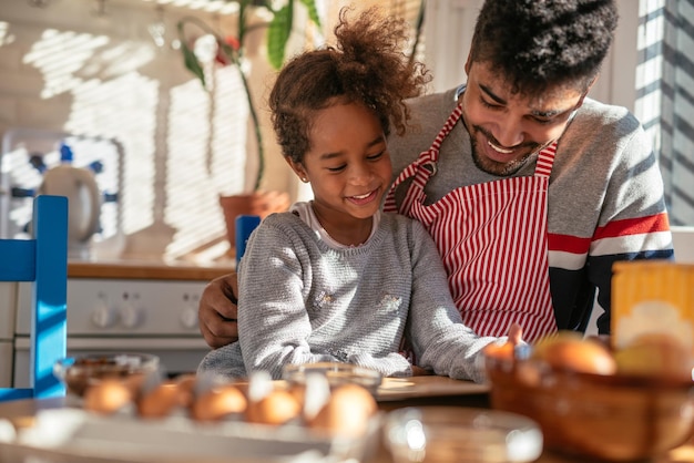 African american father and daughter preparing to bake