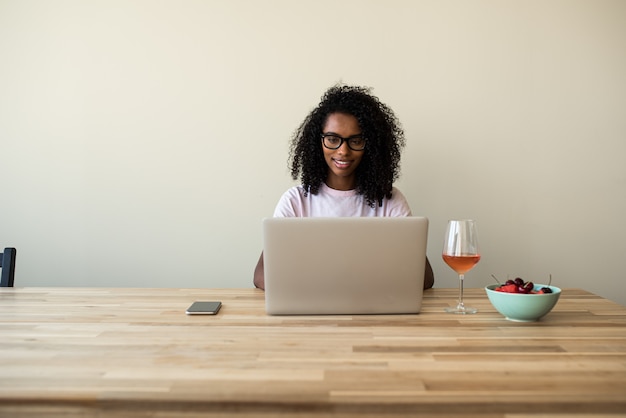 African American female freelancer using laptop at home