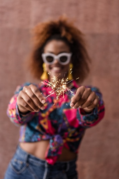 African American female with crossed sparklers