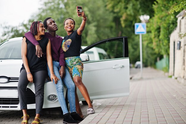 african american friends stay near car