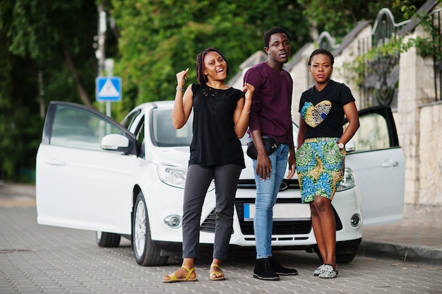 african american friends stay near car