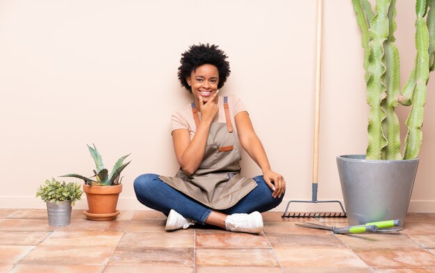 African American gardener woman sitting on the floor