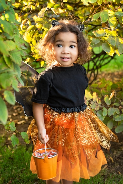 African American girl dressed as a witch and cat ears wizard for halloween Trick or treat