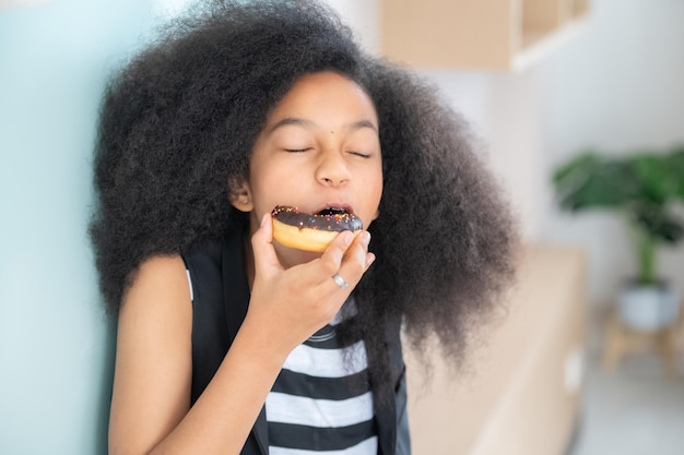 African American girl eating donut