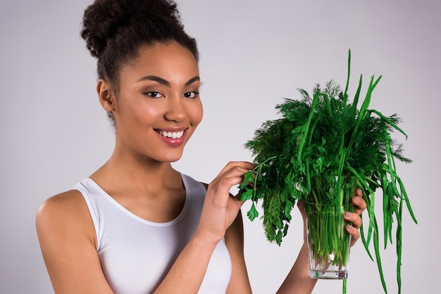 African American girl holding greens isolated.