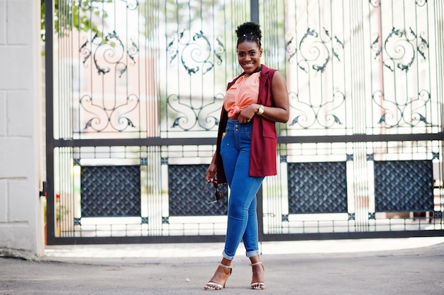 African american girl posed against stell gates outdoor