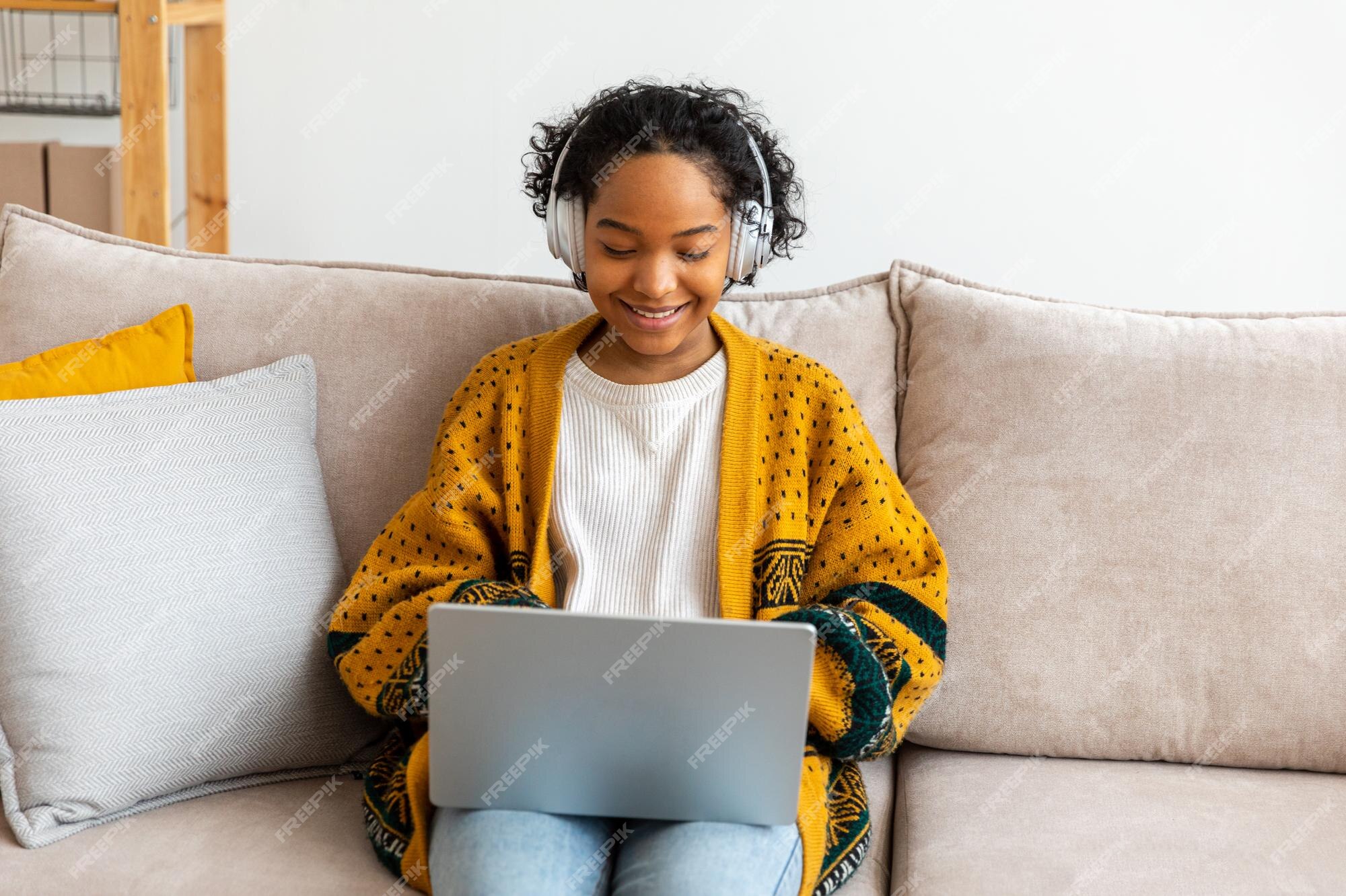 African girl friends chat online. Girl sitting in a chair in front of a  laptop and speaks with friend. Video conference, online chat concept.  Working or online meeting from home. Vector illustration.