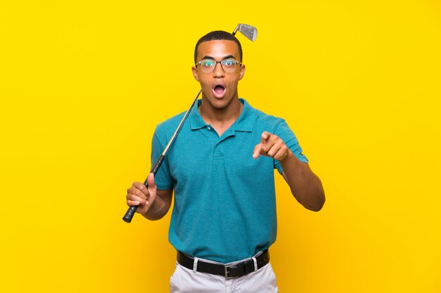 African American golfer player man surprised and pointing front