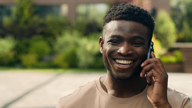 African american happy laughing smiling joyful man ethnic talking mobile phone guy laugh smile