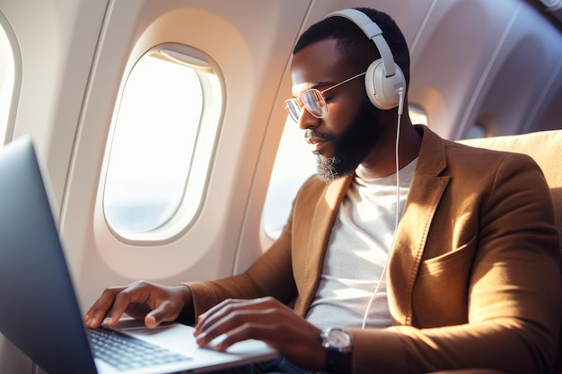 African American jetsetter Inair work session with laptop and headphones