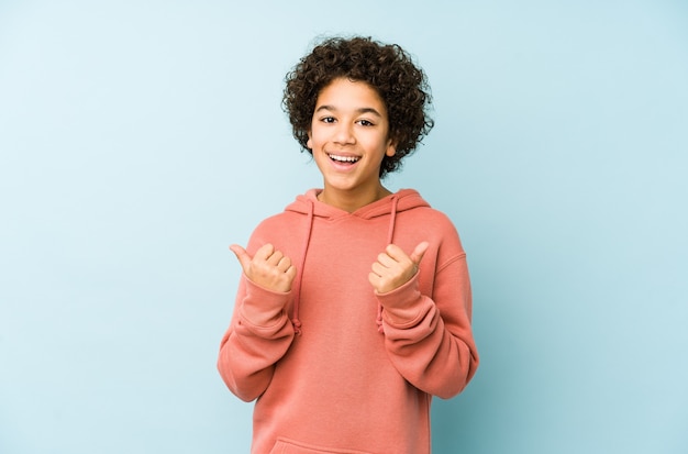 African american little boy isolated raising both thumbs up, smiling and confident.