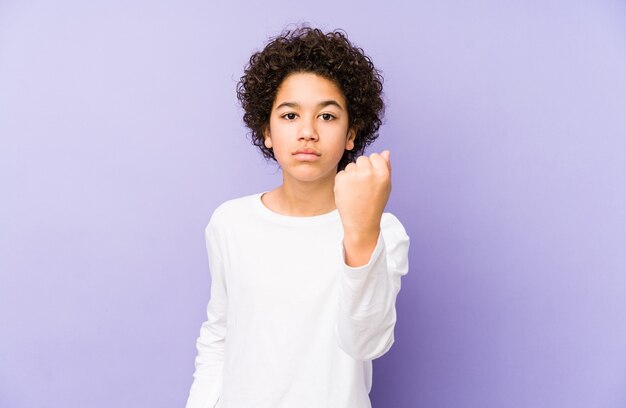 African american little boy isolated showing fist, aggressive facial expression.