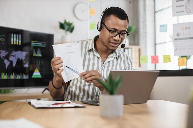 African american male office worker in eyeglasses striped shirt and headset