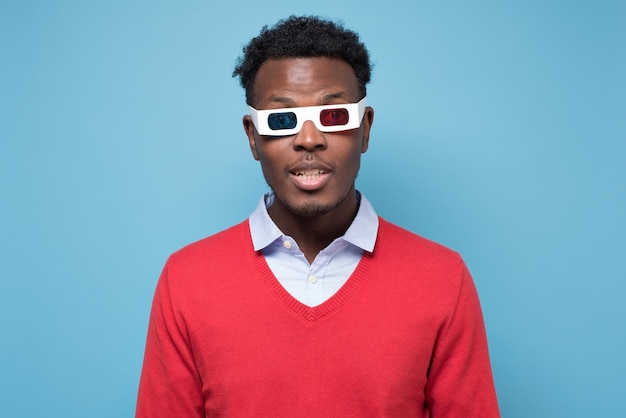 African american man in 3D glasses watching interesting movie on screen