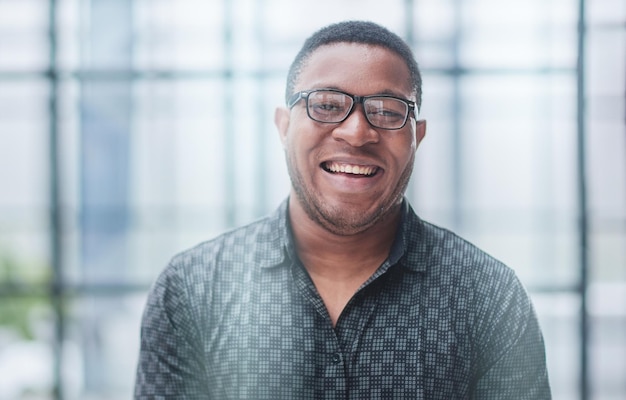 African american man in blurred office closeup