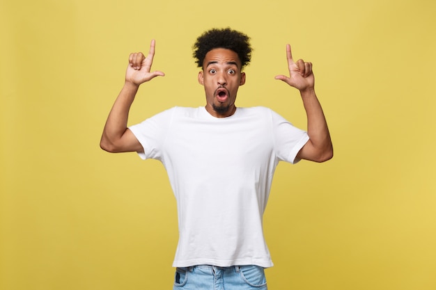 African American man in casual white shirt having excited look