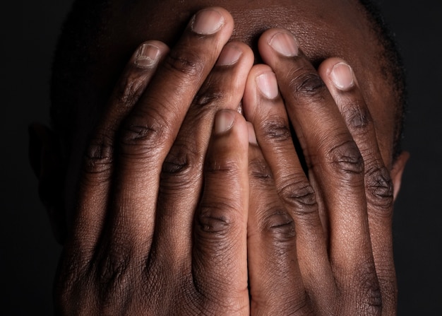 African american man, cover his face with hands