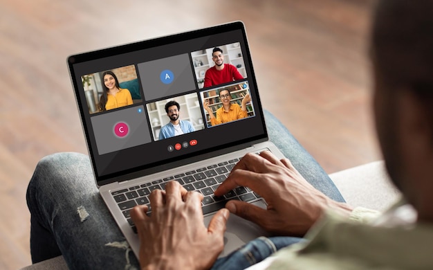 African american man enjoying video chat with friends