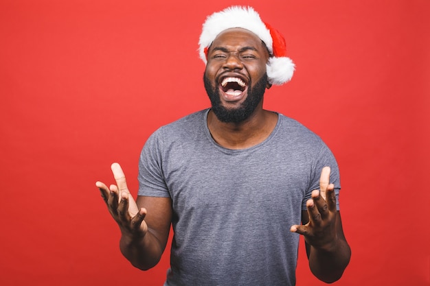 African American man in grey T-shirt and Santa hat