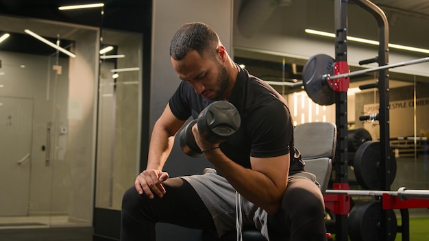 African american man in gym doing biceps workout exercise male sportsman strong power bodybuilder