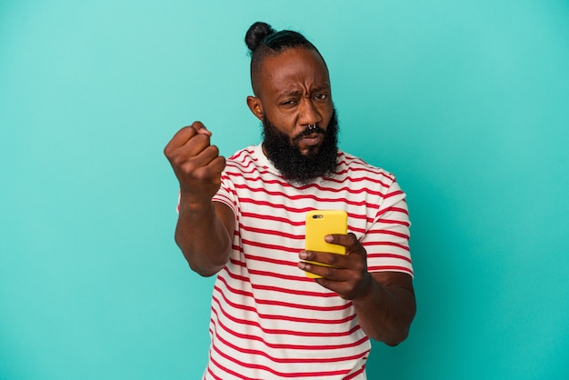 African american man holding a mobile phone isolated on blue background