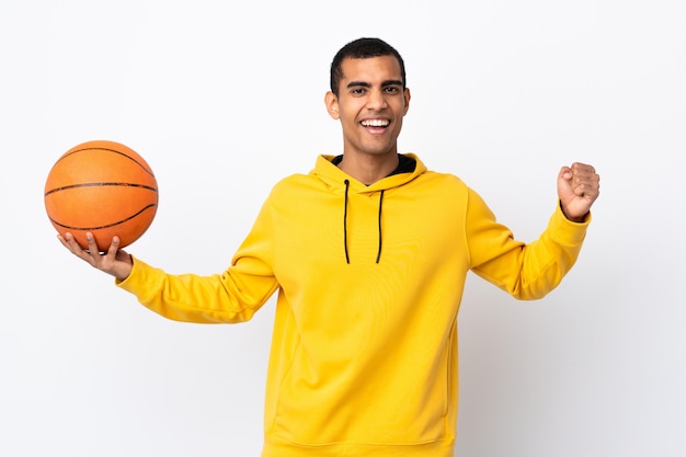 African American man over isolated white wall playing basketball