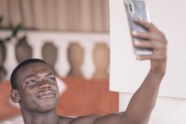 African American man joyfully browsing smartphone