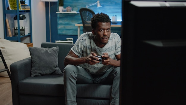 African american man losing at video games on console for fun. Black person playing online game using controller on television. african american adult with joystick feeling irritated about lost play o