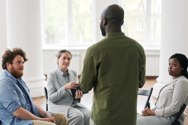 African american man sharing his trouble with patients at psychological session