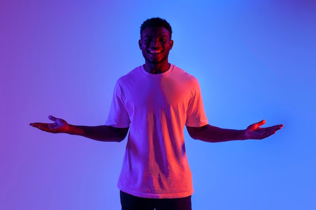 african american man shrugging his shoulders in neon lighting puzzled guy showing embarrassment