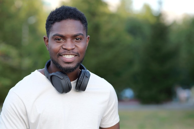 African american man stands demonstrating toothy smile