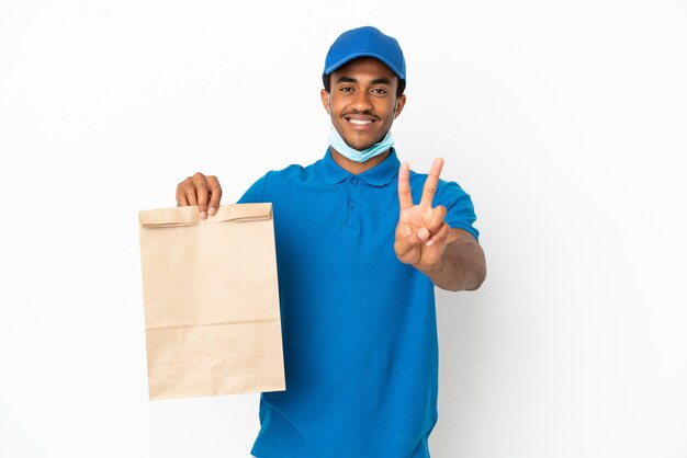 African American man taking a bag of takeaway food isolated on white background smiling and showing victory sign