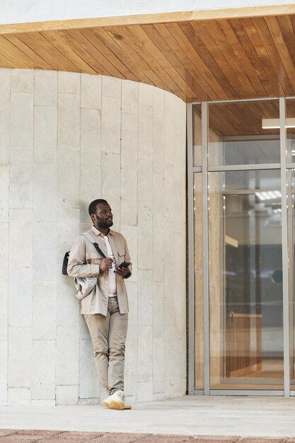 African American Man Waiting By Office Building