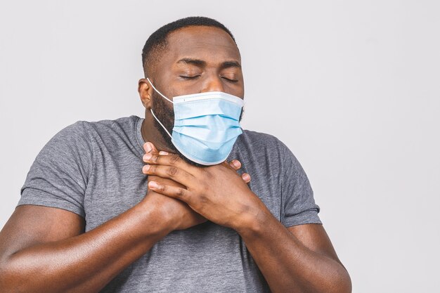 African american man wearing hygienic mask to prevent infection, airborne respiratory illness