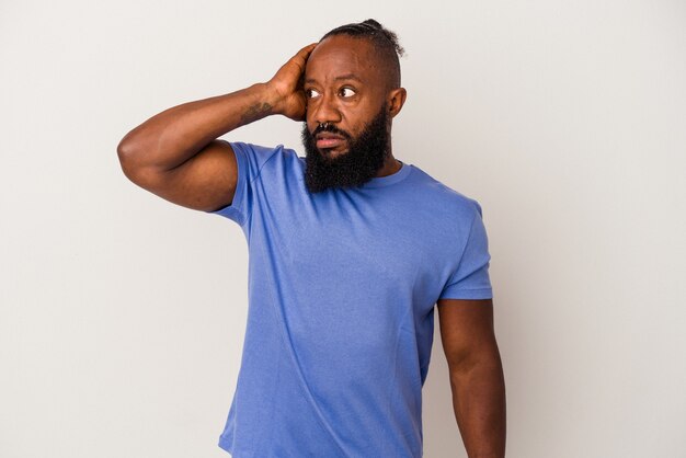 African american man with beard isolated on pink background being shocked, she has remembered important meeting.