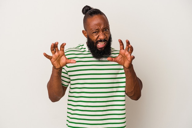 African american man with beard isolated on pink background showing claws imitating a cat, aggressive gesture.