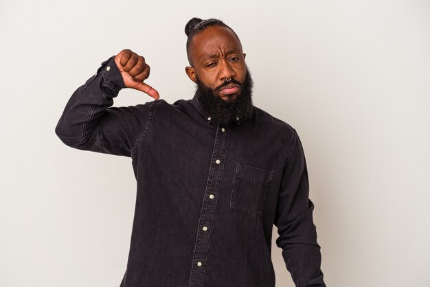 African american man with beard isolated on pink background showing a dislike gesture, thumbs down. Disagreement concept.