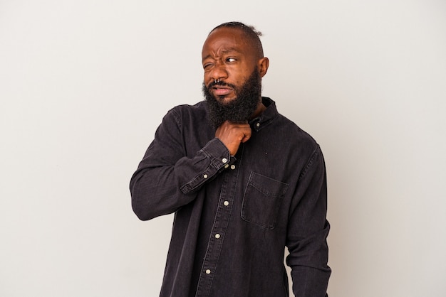 African american man with beard isolated on pink background touching back of head, thinking and making a choice.