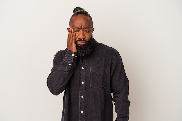 African american man with beard isolated on pink wall who feels sad and pensive, looking at copy space.