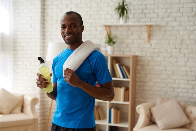 African American man with bottle is having rest.