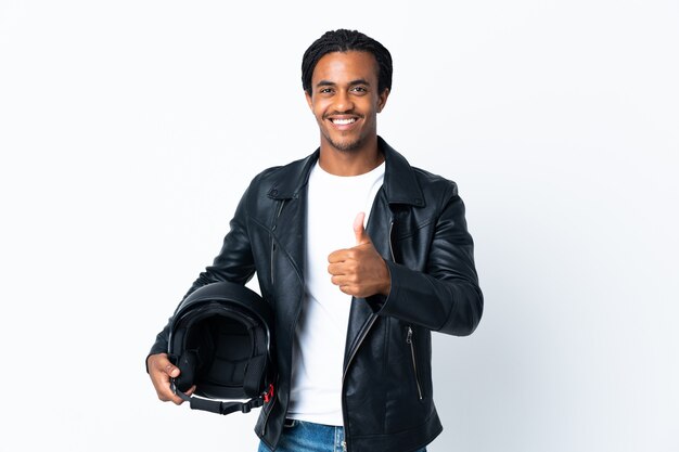 African American man with braids holding a motorcycle helmet on white giving a thumbs up gesture