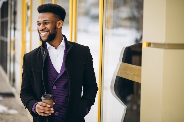 African american man with coffee outdoors