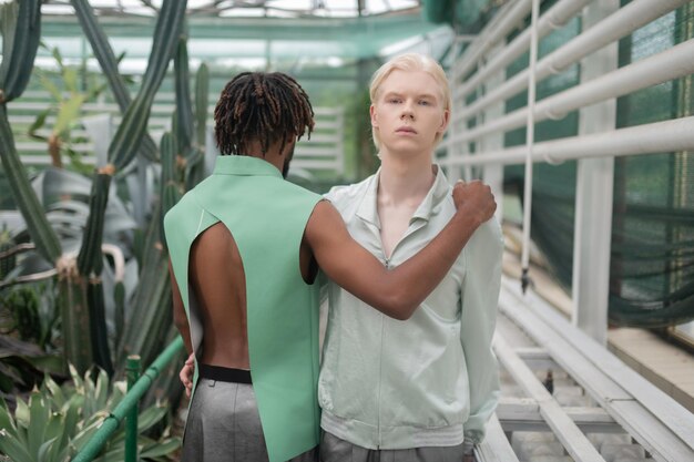 African American man with dreadlocks hugging handsome blonde man