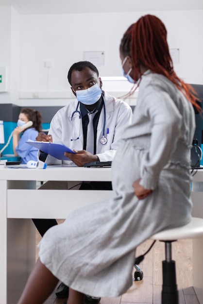 African american medic and patient at checkup visit