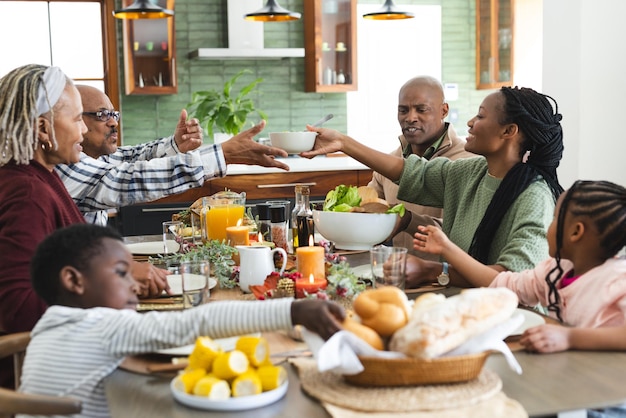 African american parents children and grandparents celebrating at thanksgiving dinner