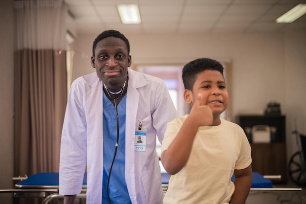 African American pediatric doctor with kids patient in hospital African American male pediatrician