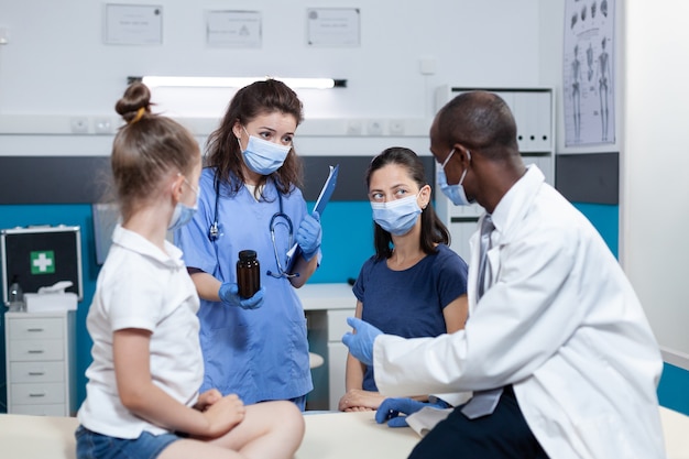 African american pediatrician doctor with protective face mask against coronavirus