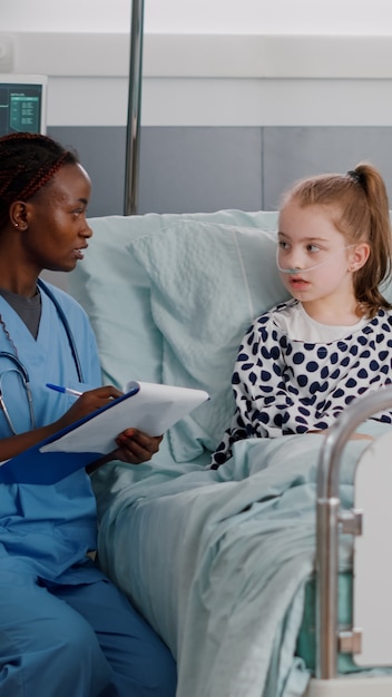 African american pediatrician woman nurse explaining healthcare treatment